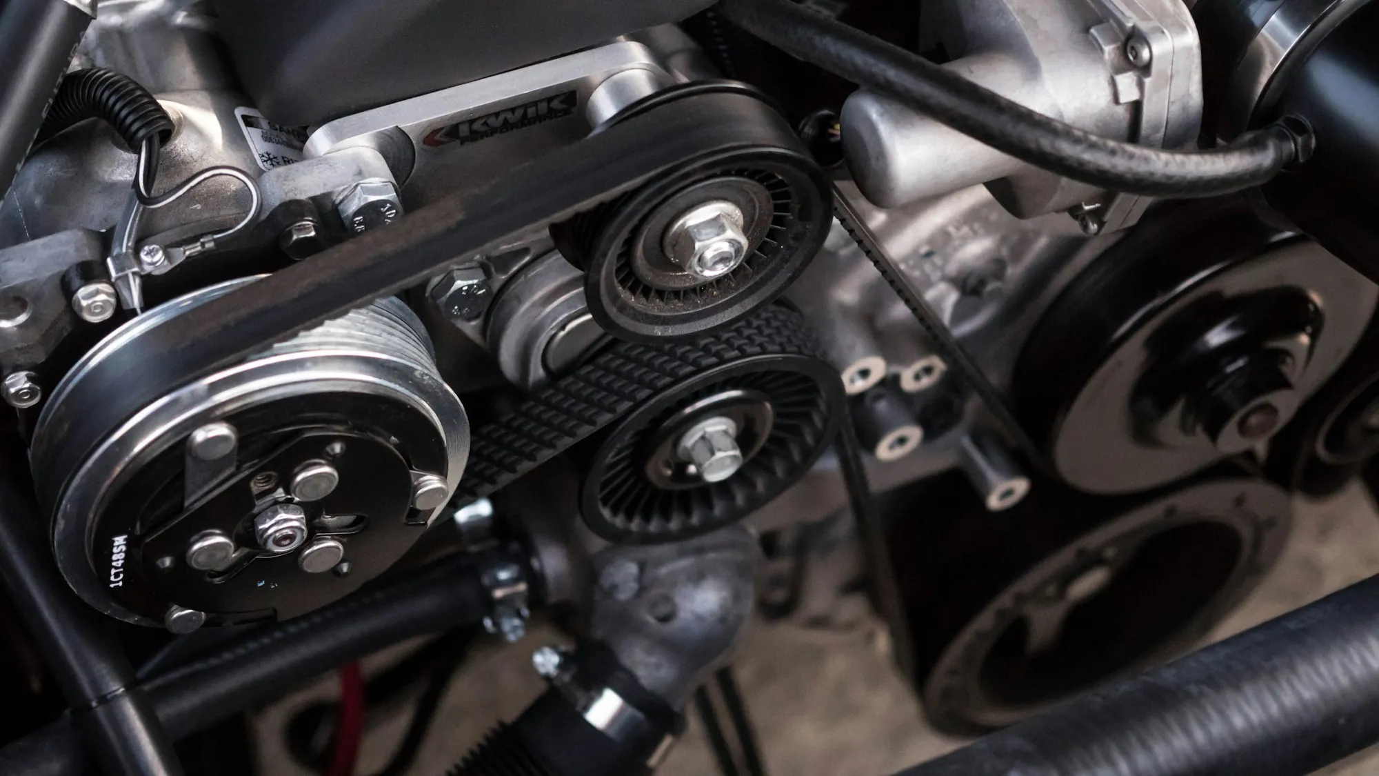 Close view of an engine's belt drive and pulleys