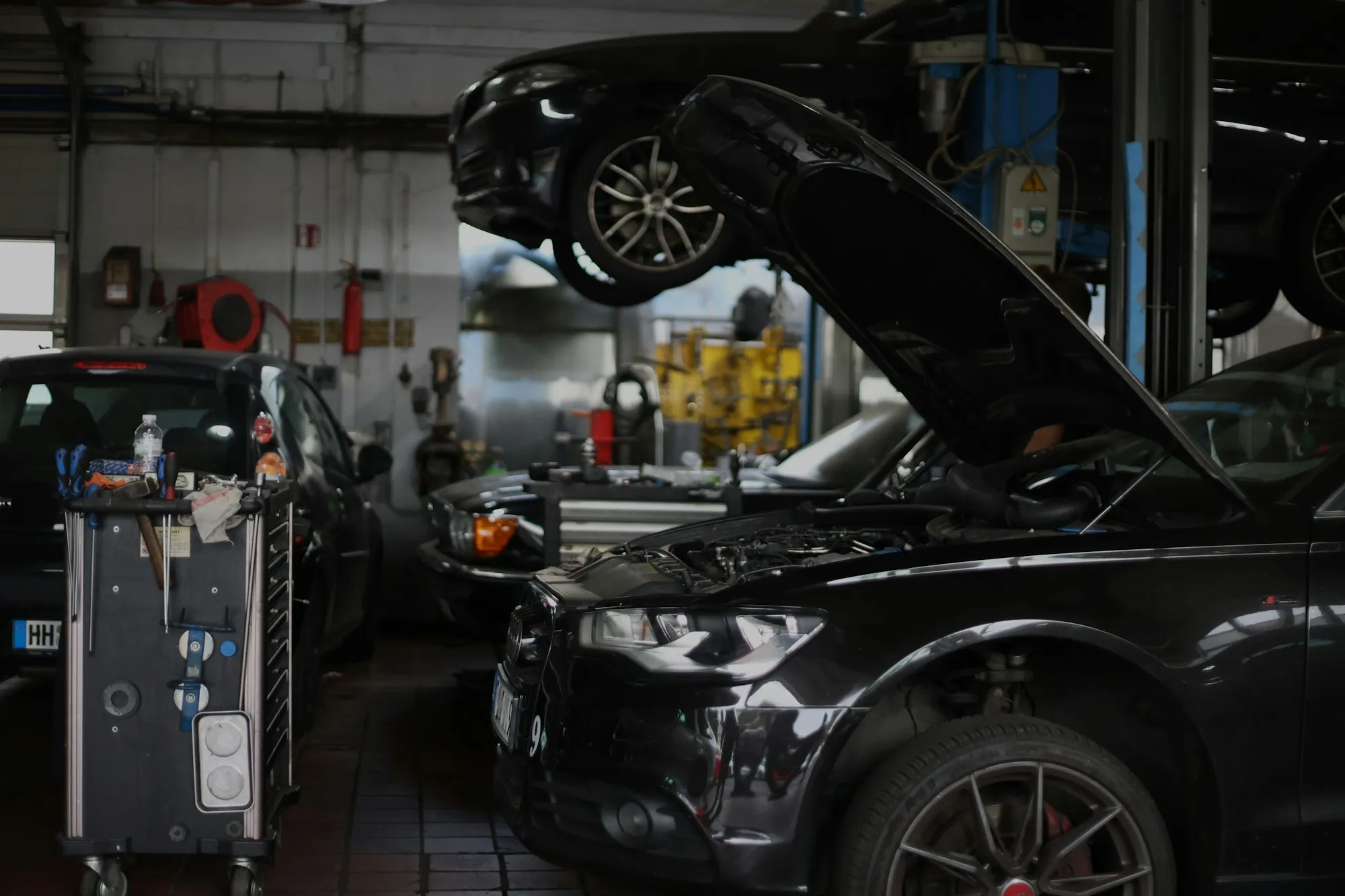 Clean repair shop with vehicles raised on lifts